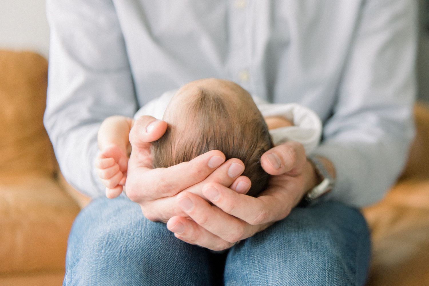 babies head in dad's hand at Washington DC Newborn session