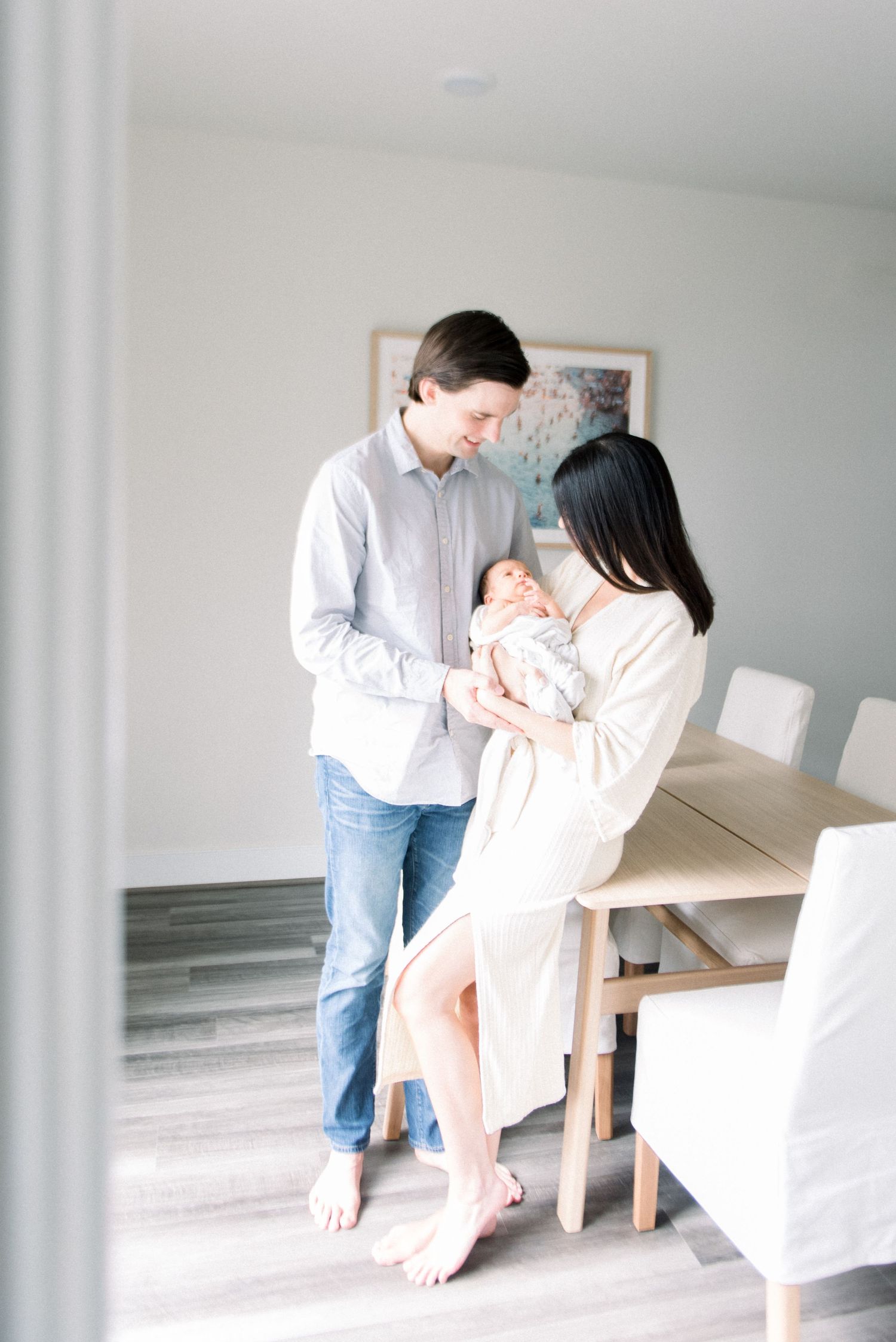 Mom and dad standing holding newborn at DC Newborn photography session