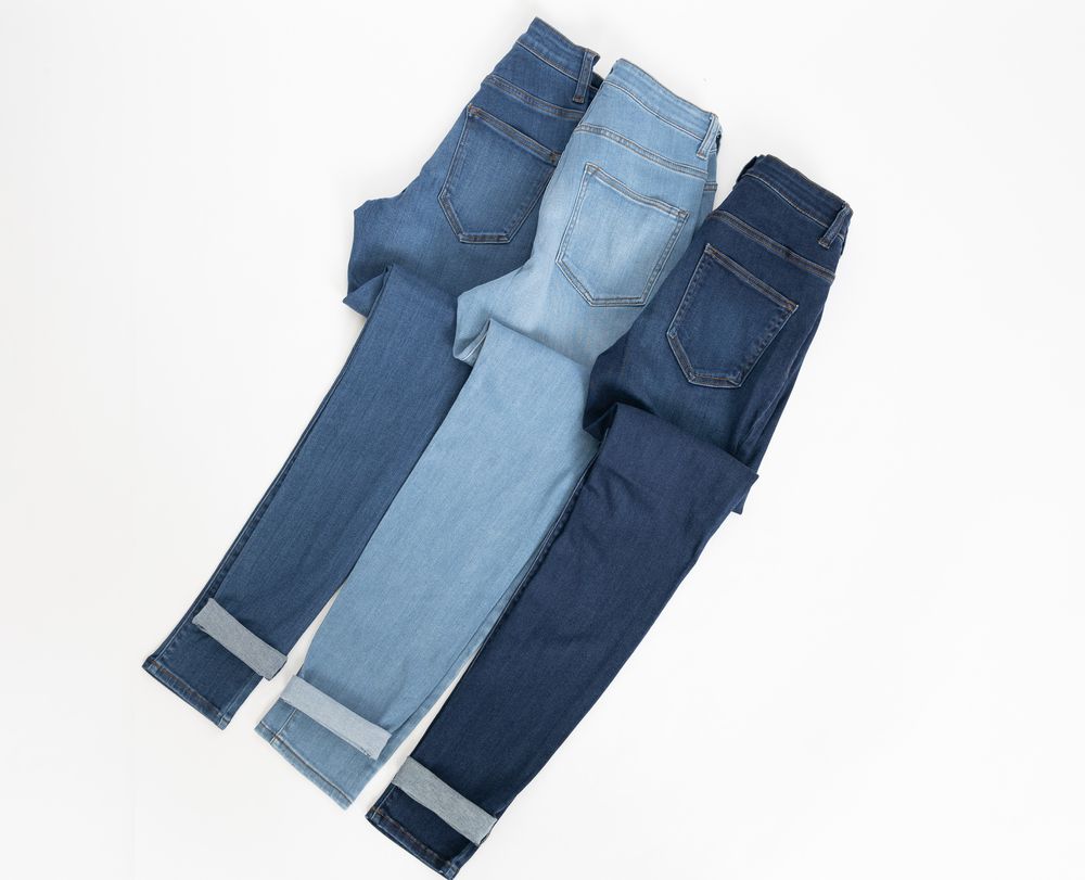 three pair of blue jeans in light, medium and dark wash