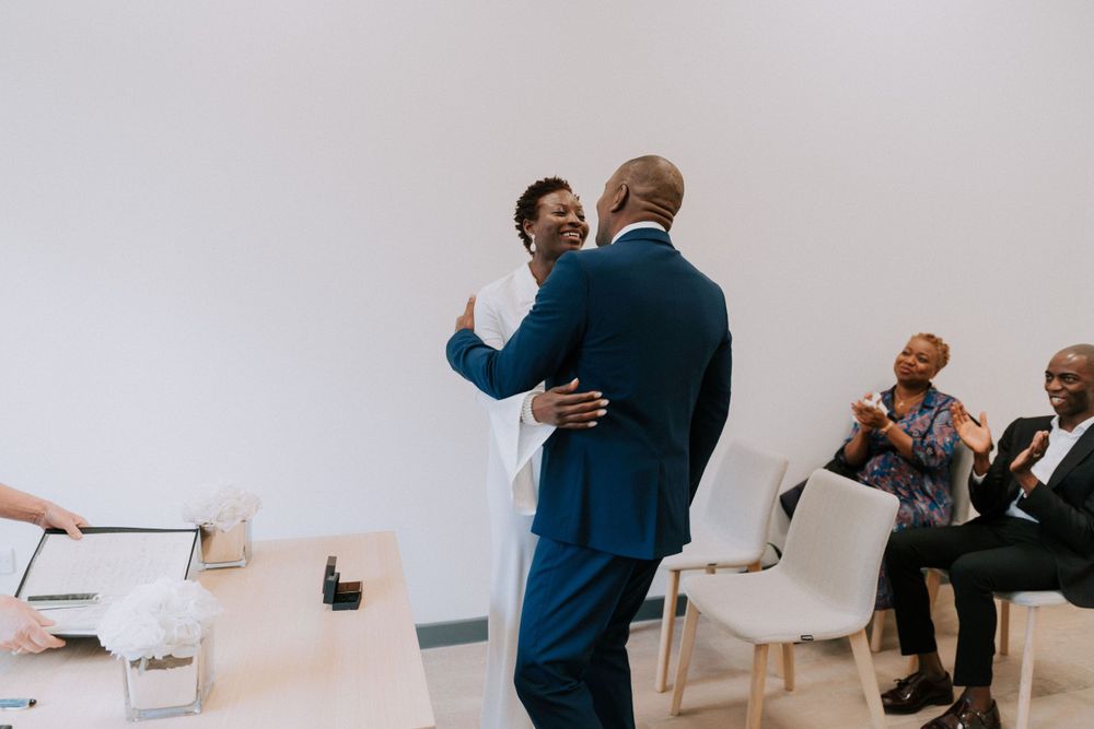 A couple shares an intimate moment during a courthouse wedding ceremony.