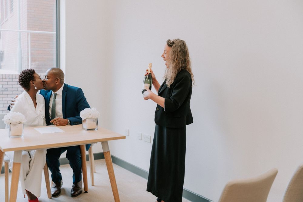 People gather in a bright modern room for a special ceremony.