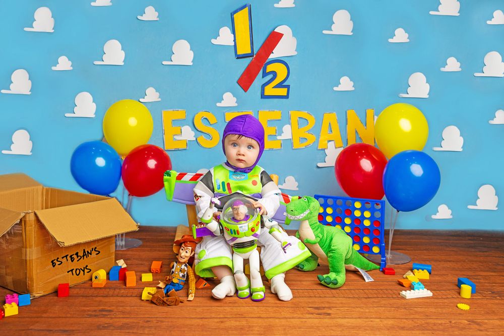 Toy Story themed half birthday celebration with Buzz Lightyear figures and balloons.