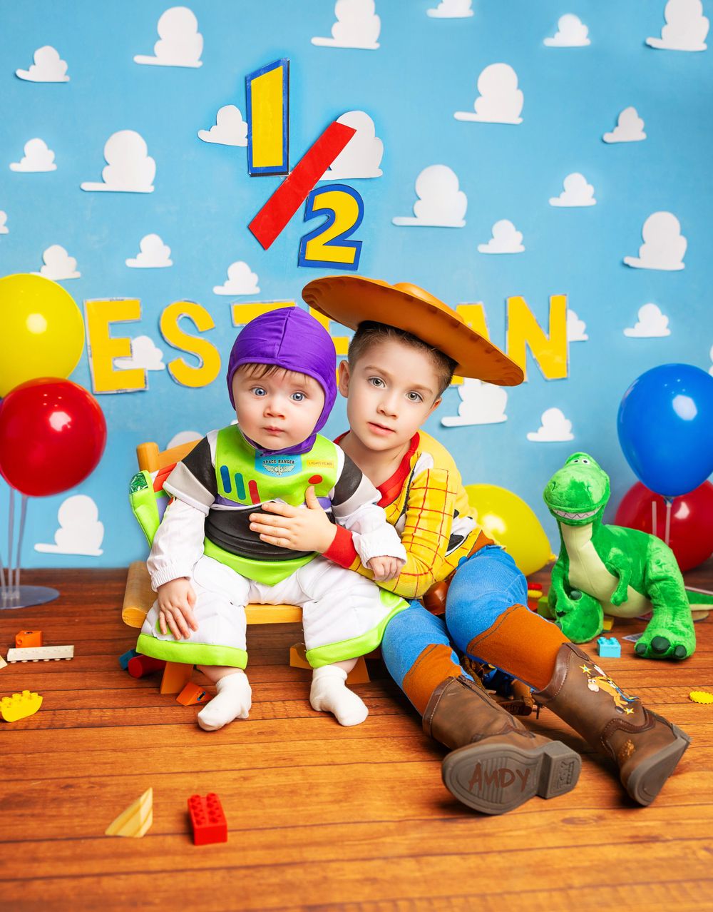 Toy Story themed birthday setup with Buzz Lightyear and Woody costumes against cloud background.