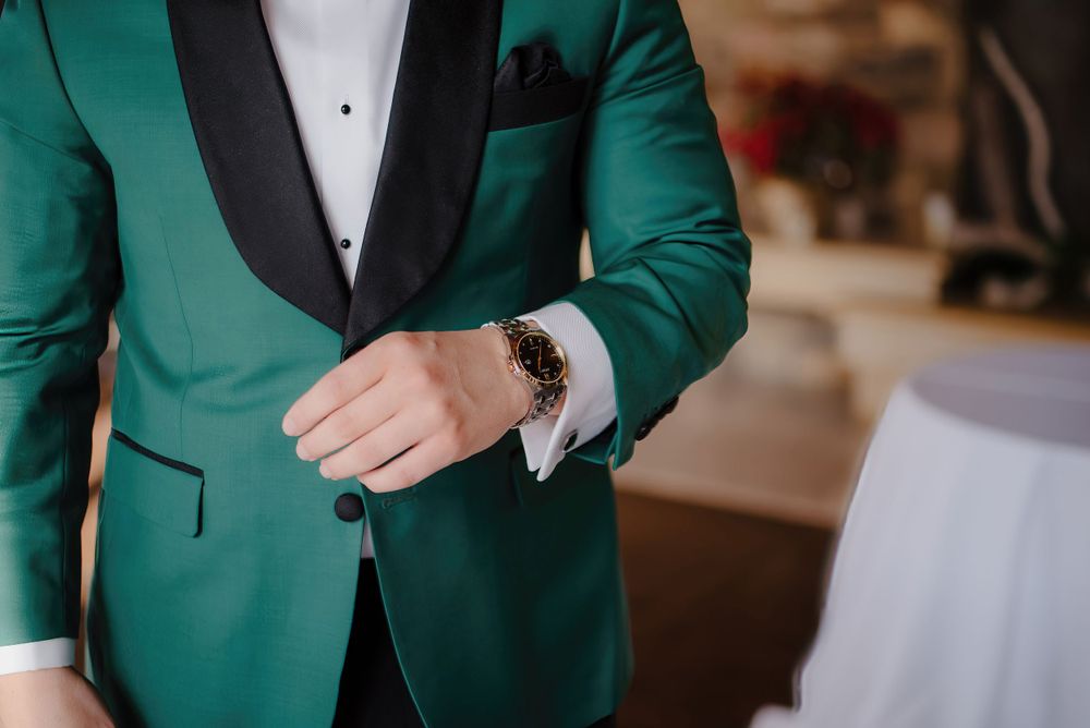 Detail shot of emerald green tuxedo jacket with black lapels.