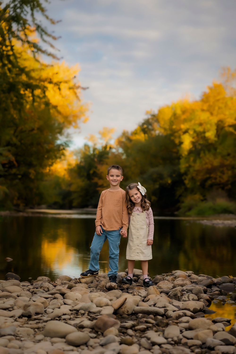 Autumn photo of kids at river bank