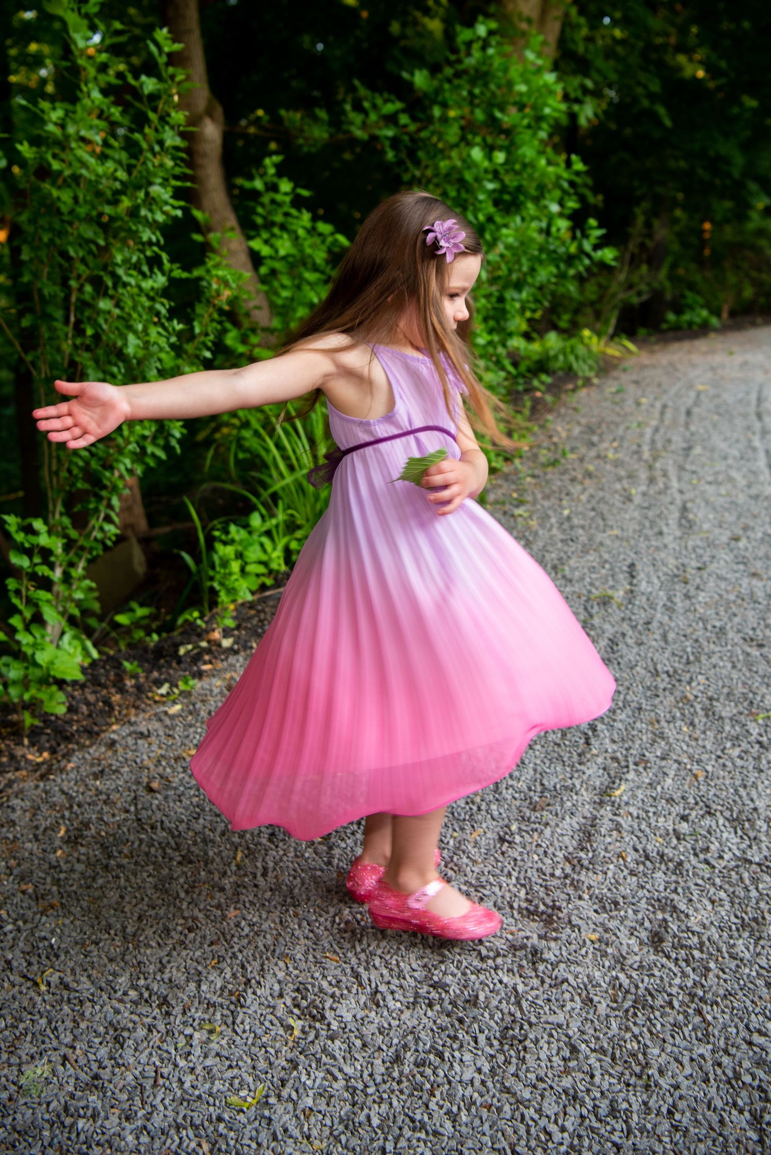 four year old girl twirling in pink dress