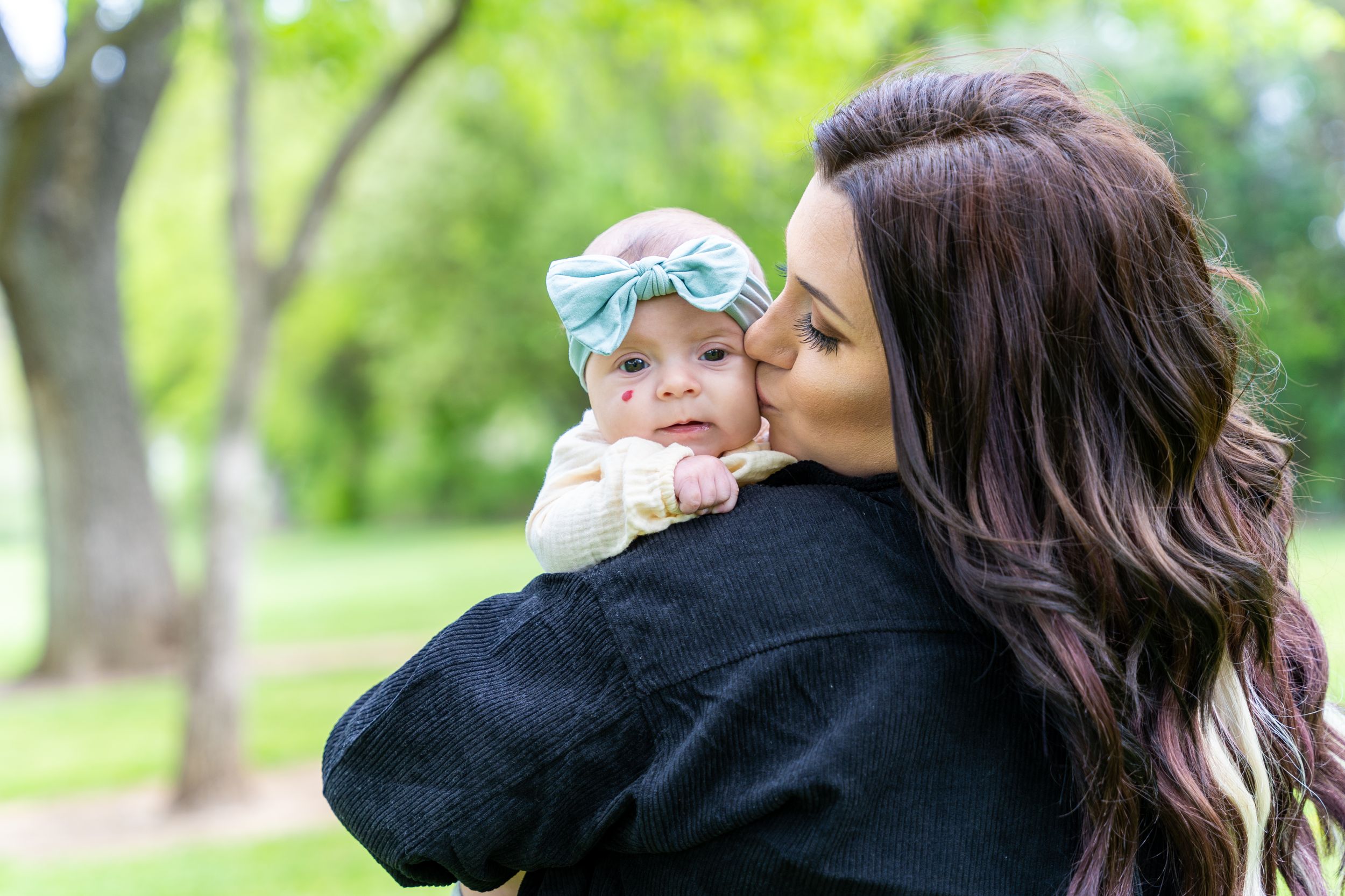 Tender moment as a loving mother kisses her adorable baby with affection and warmth