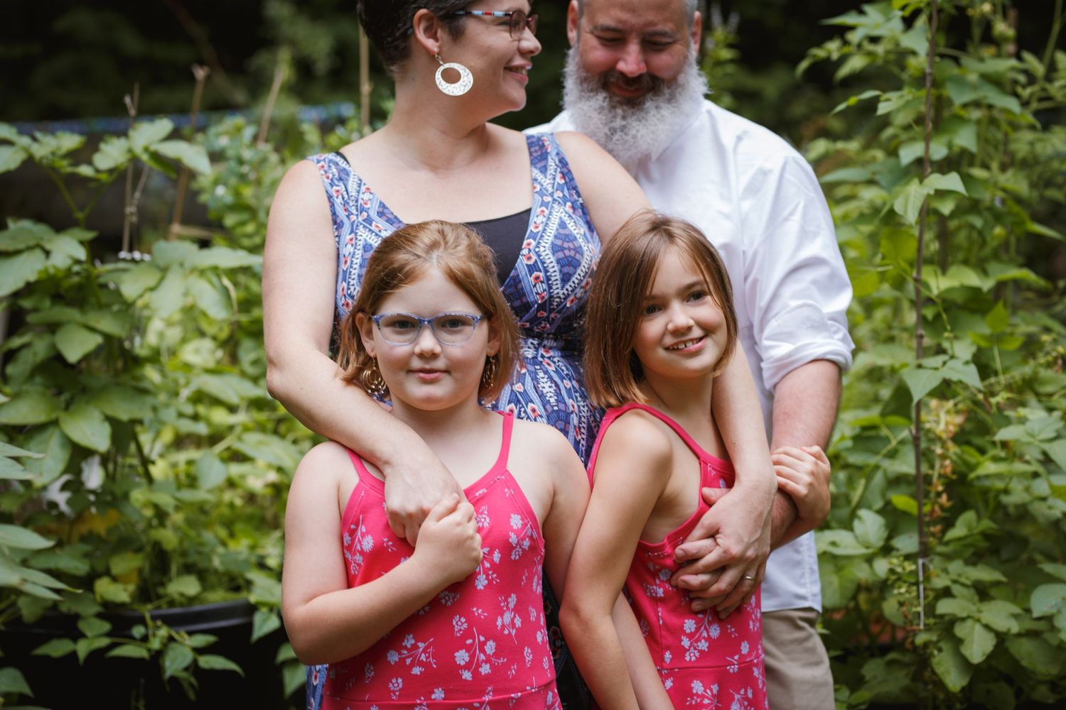 seattle family photographer: a mother and father with their daughters at a family photo session