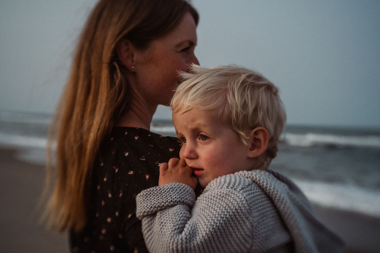 mom holding toddler boy on the beach in virginia beach, virginia family photographer