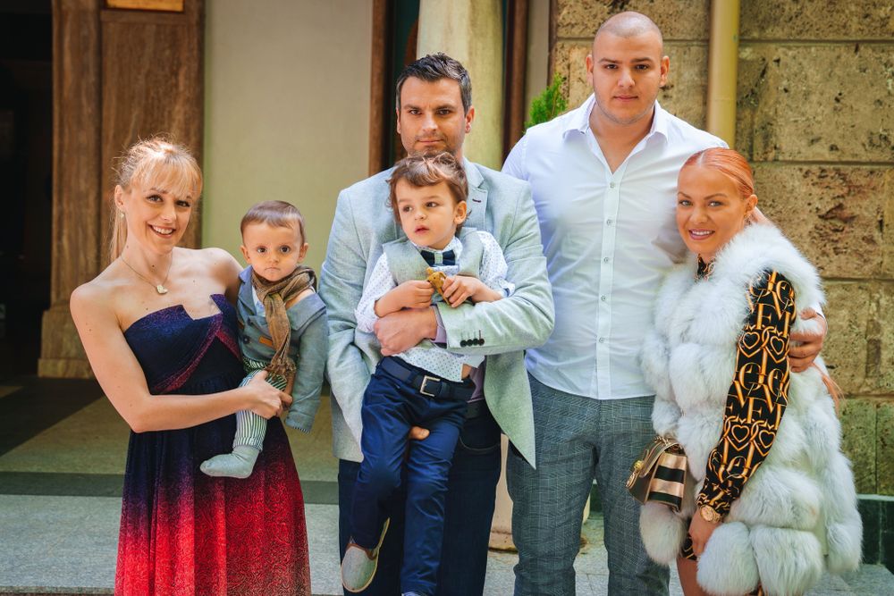 Group photo of family members gathered outside church entrance.