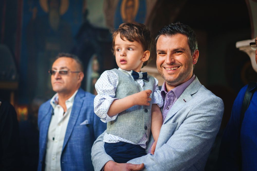 A joyful moment captured during a religious ceremony for a small child.