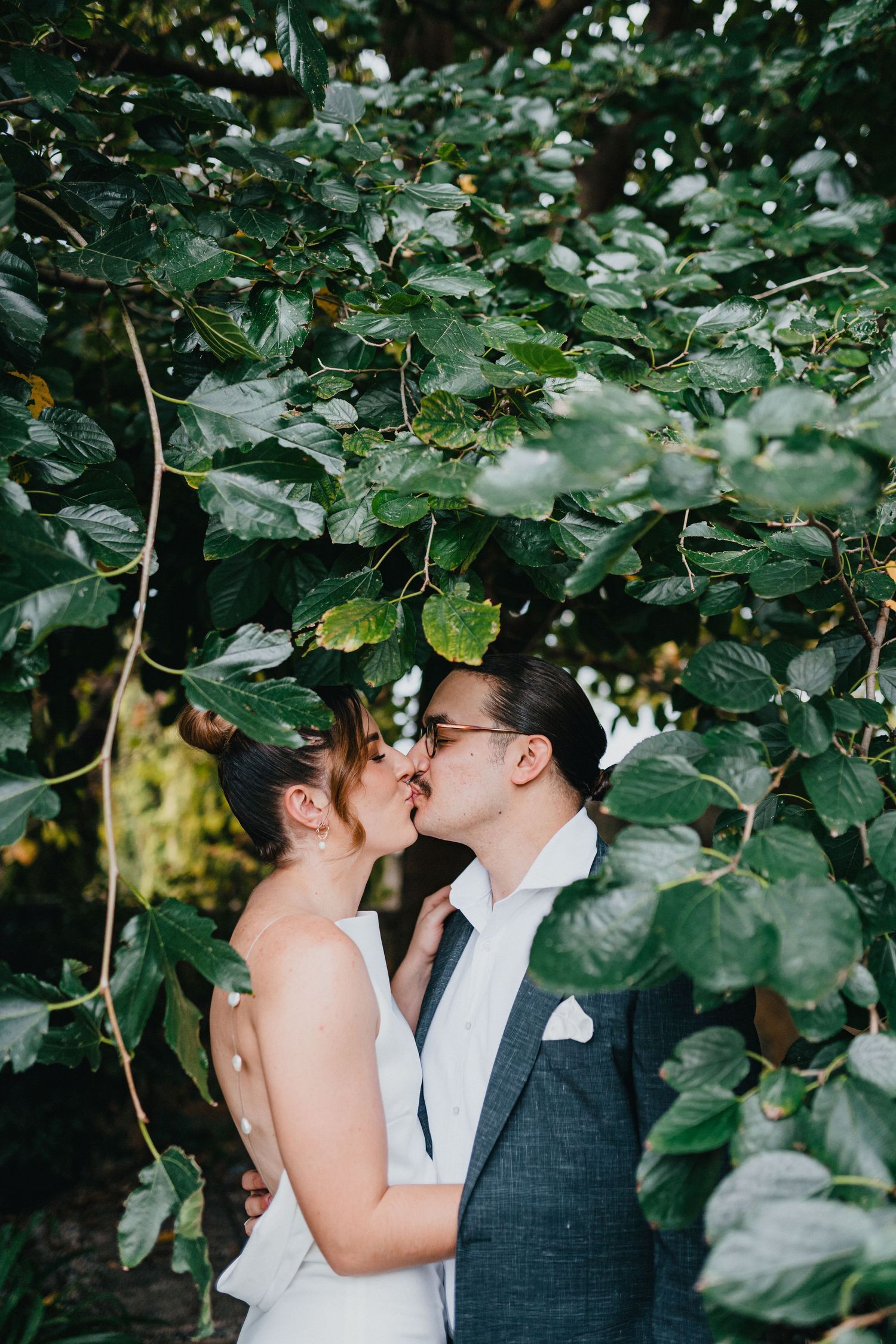 couple shoot bride and groom kiss in nature intimate wedding photography