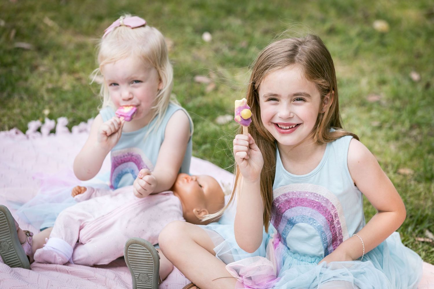 Two smiling girls eating ice cream