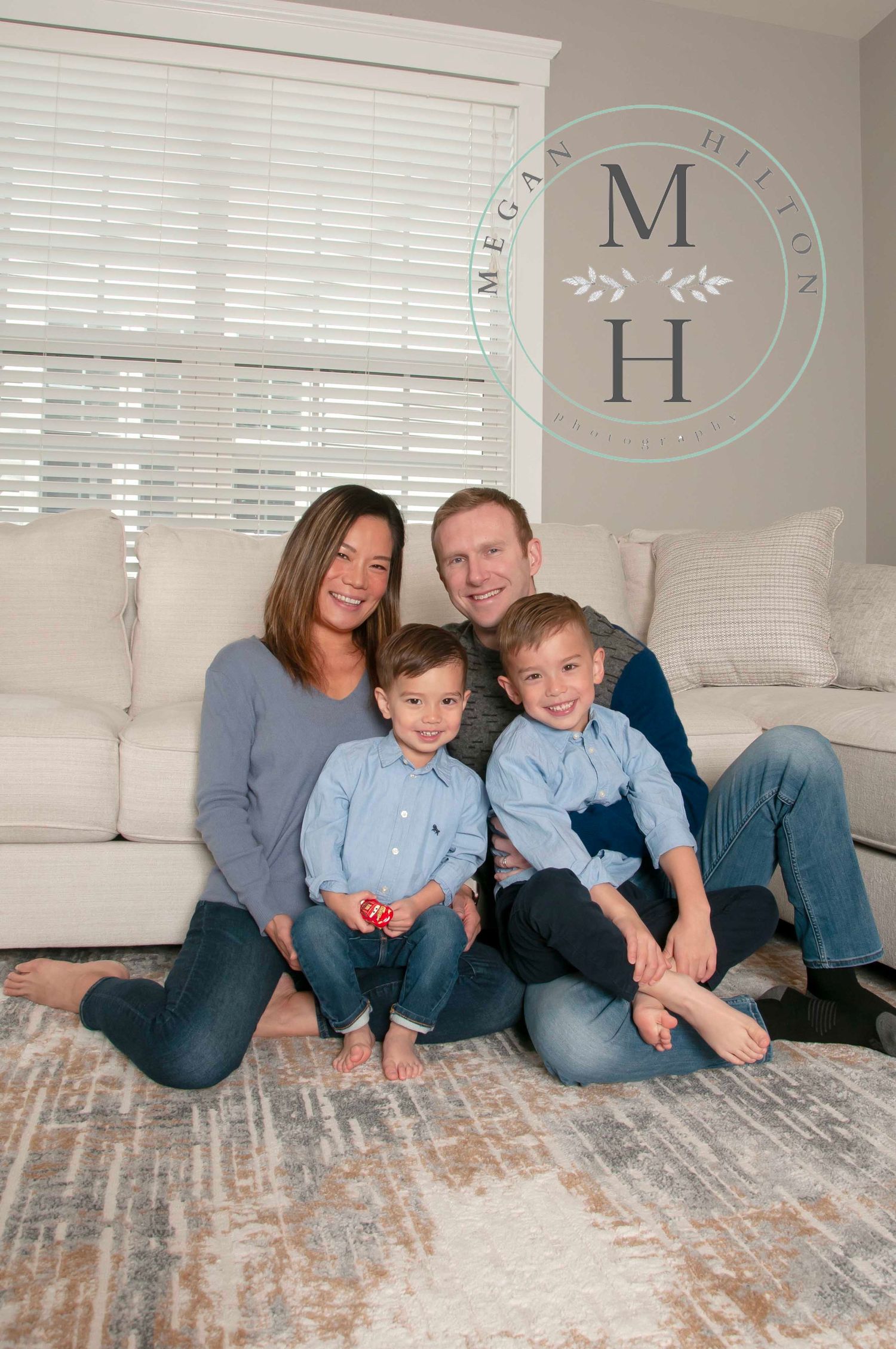 Family pose sitting on living room floor