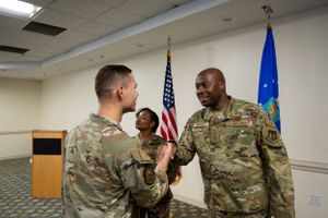 Service members participating in a military promotion ceremony.