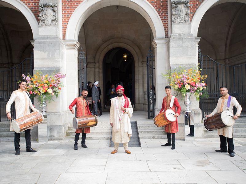 Dohl Drummers accompany groom at the start of this beautiful wedding. Photography at Harrow School by Abigail's Studio