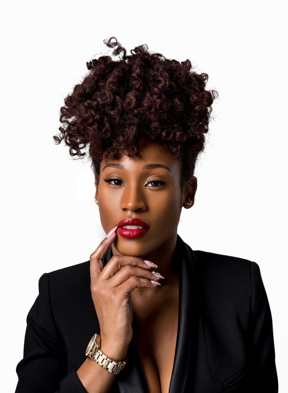 Stunning beauty portrait featuring curly updo, red lipstick and black blazer.