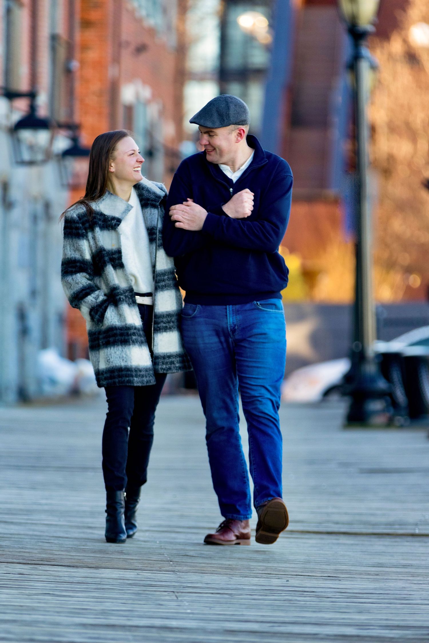 A young engaged couple cherishes their time together in historic Boston, Massachusetts, smiling in love at each other.