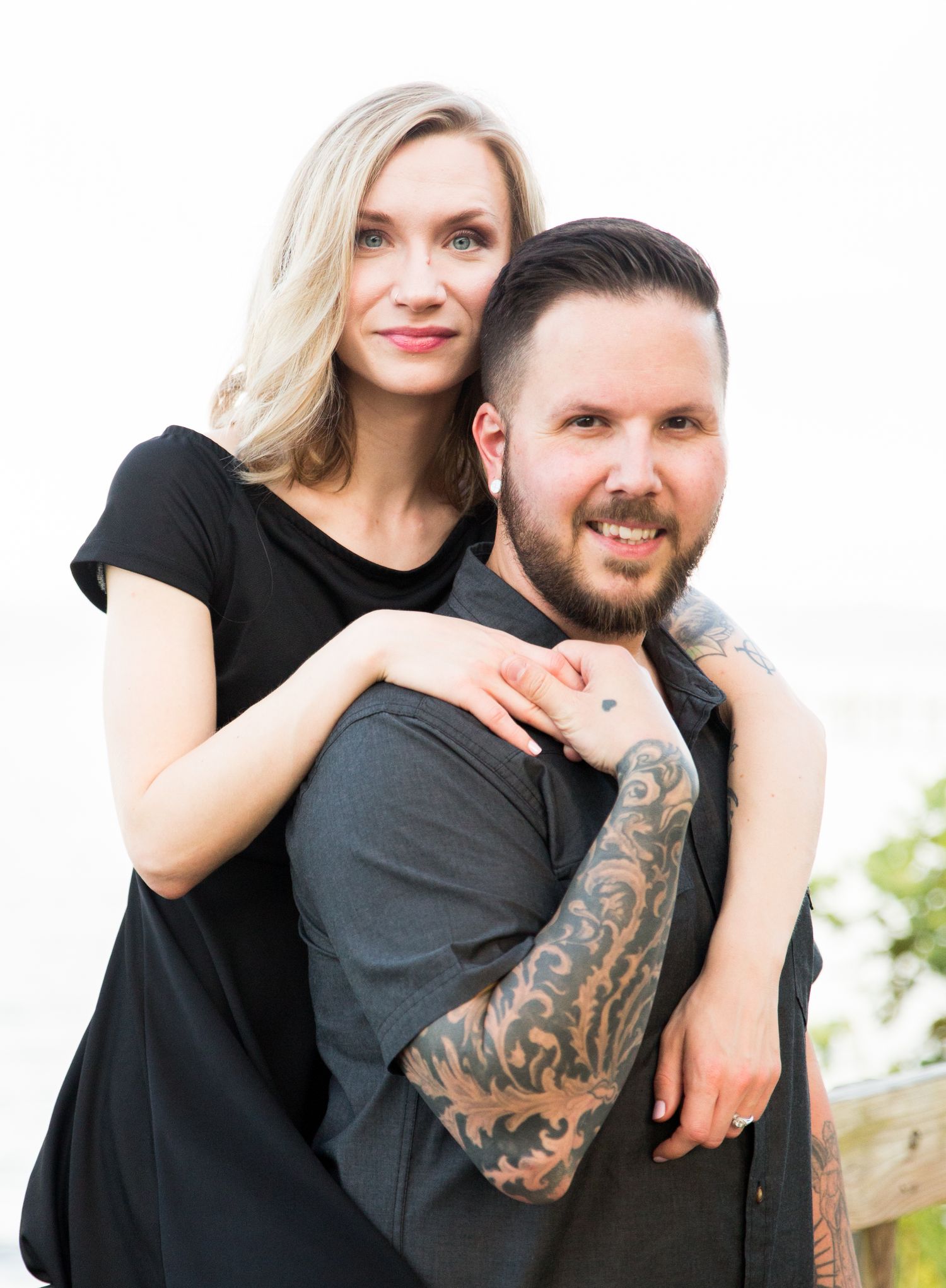 Tattoo groom and bride to be embrace during thier engament photo session in Maryland with DANIE photography