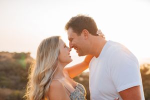 Romantic couple portrait during sunset with soft golden light.