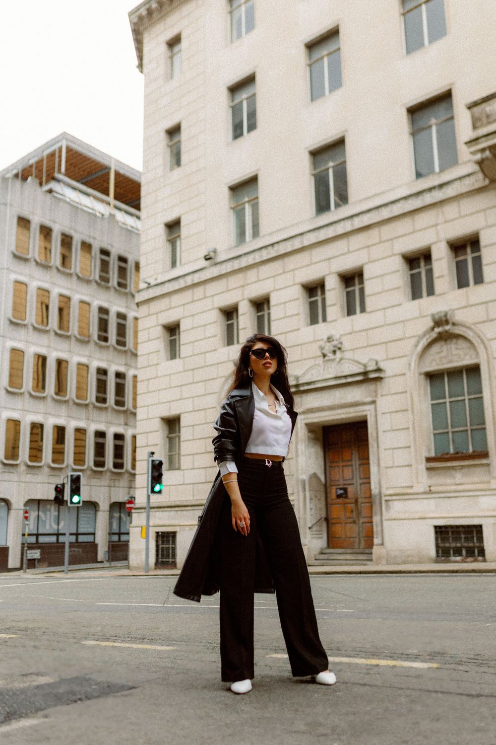 Fashion shoot in front of a white stone building with architectural details.
