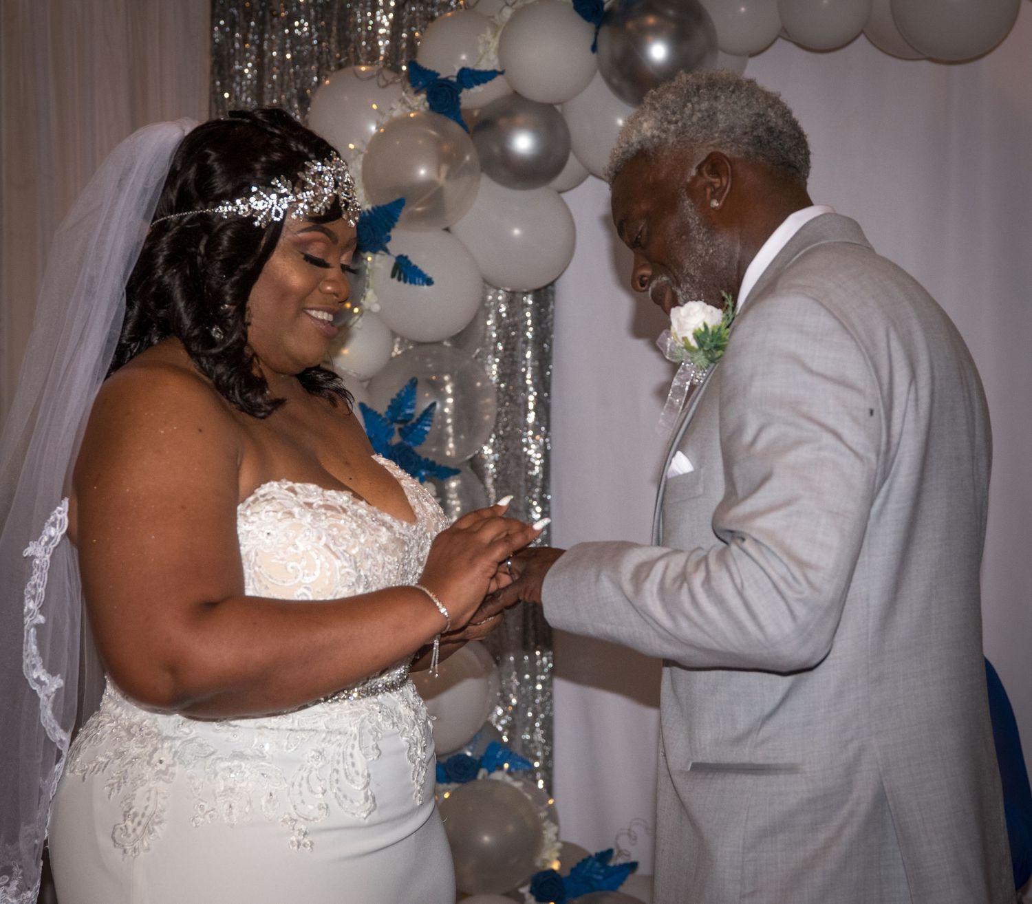 Wedding reception scene with silver and white balloon decorations.