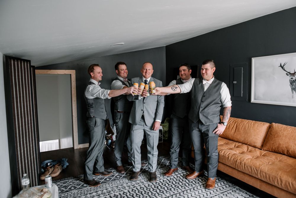 Group photo showing matching grey suits and dress shoes in modern interior.
