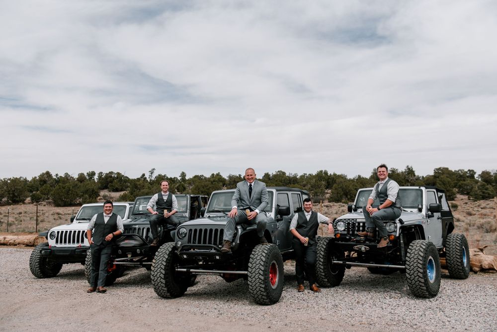 Panoramic view of multiple Jeeps lined up in an off-road desert setting.