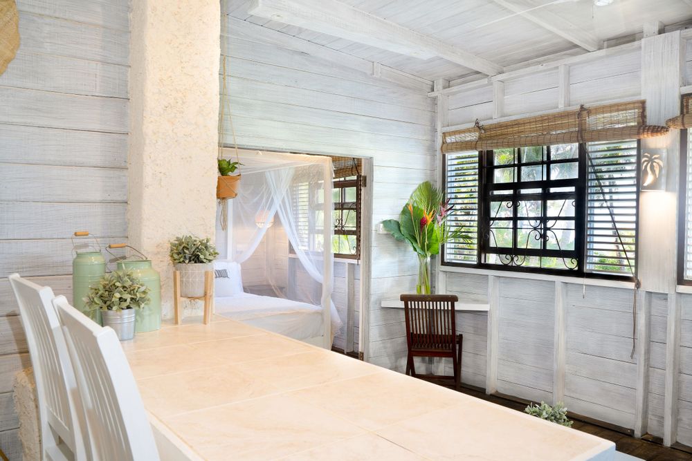 Airy white interior space with high ceilings and natural light streaming through windows.