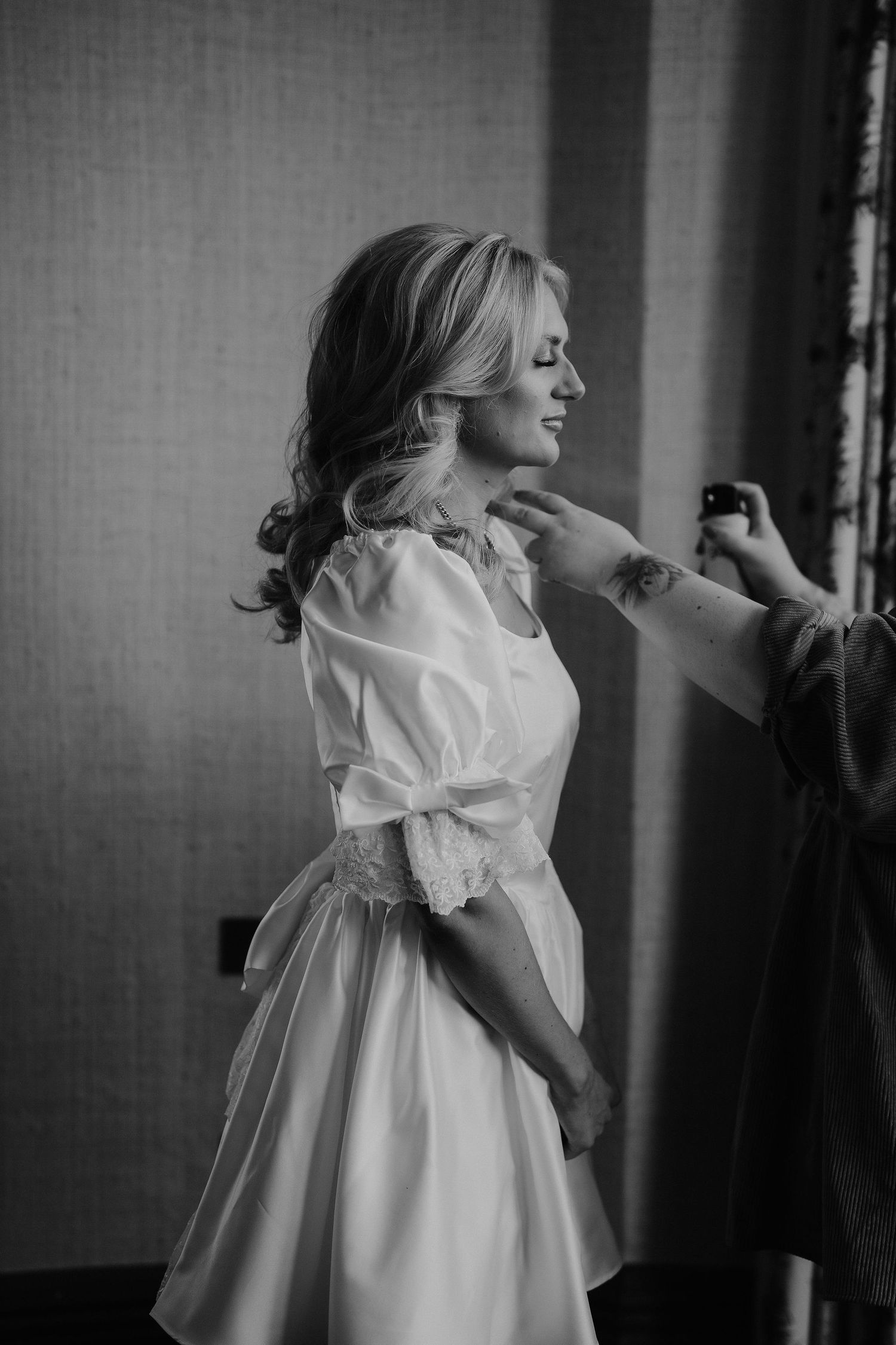 hair stylist fixing brides hair at the Randolph hotel in oxford