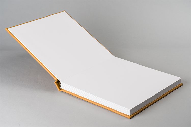 Open white album book with blank pages showing binding and construction.