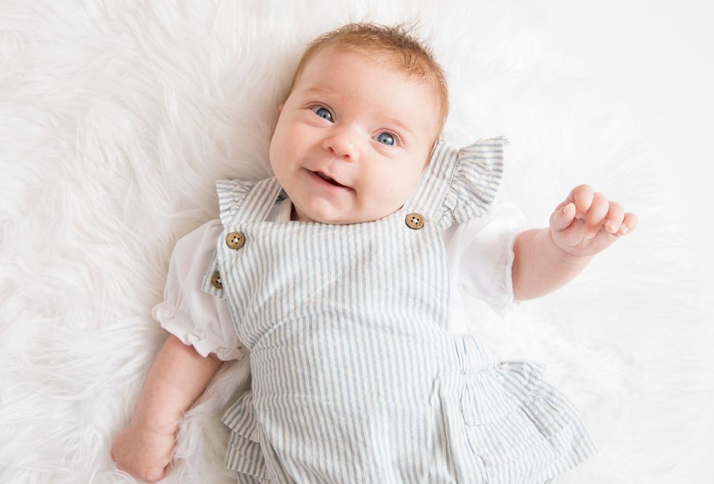 Newborn baby girl led on back.