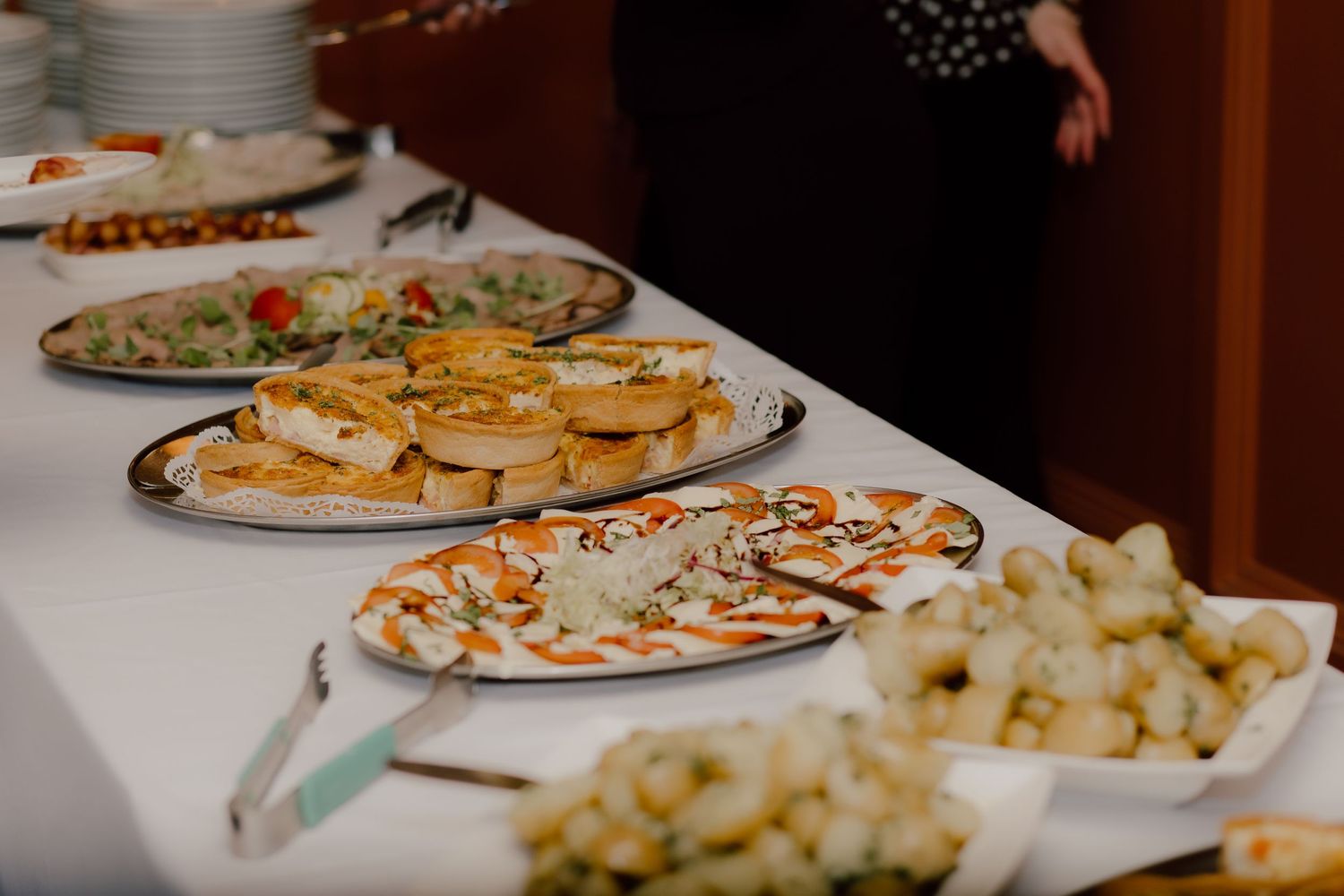 Elegant wedding reception buffet table with various appetizers and finger foods displayed.