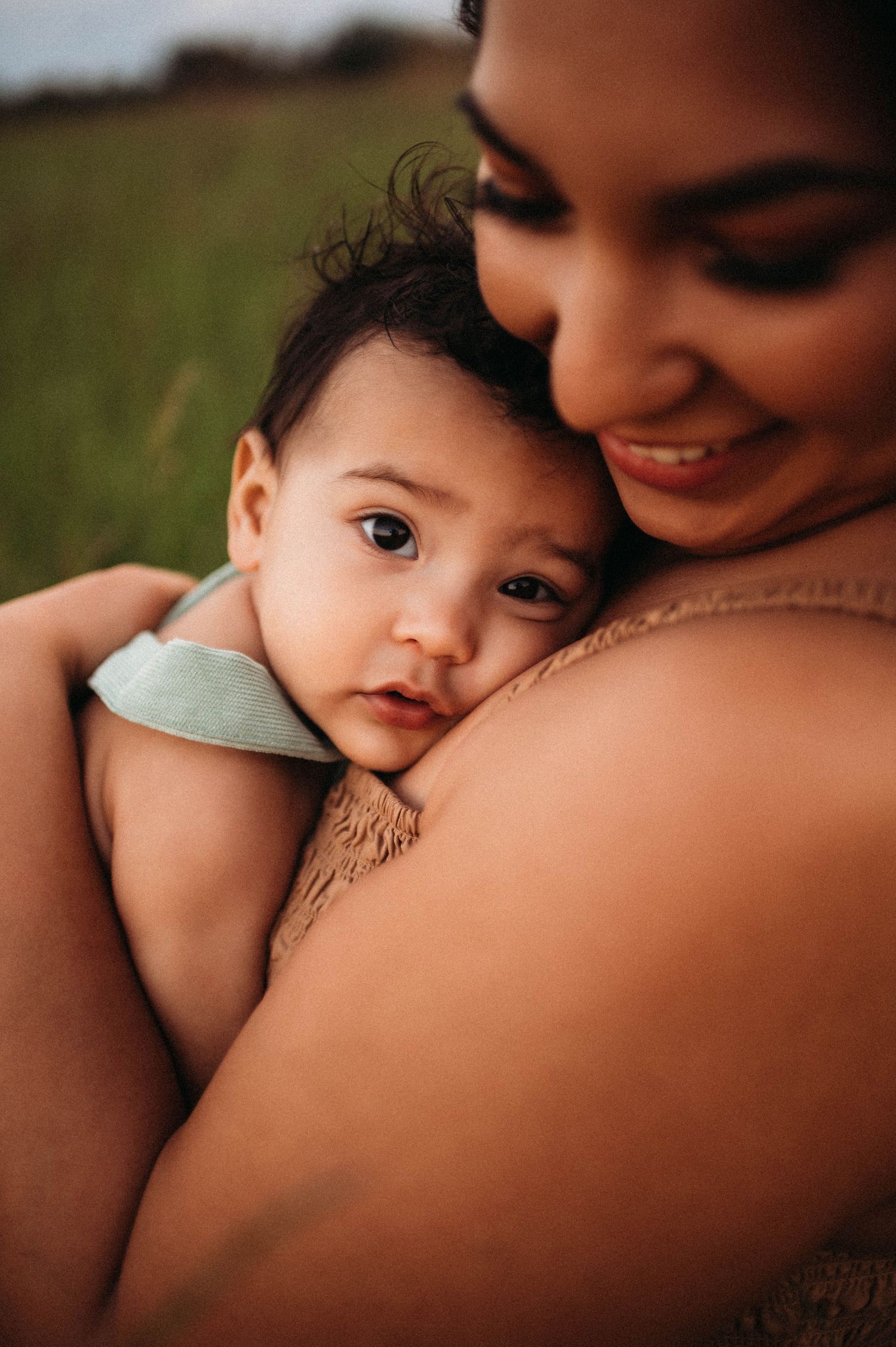 Close up portrait of mom snuggling with toddler boy in quad cities