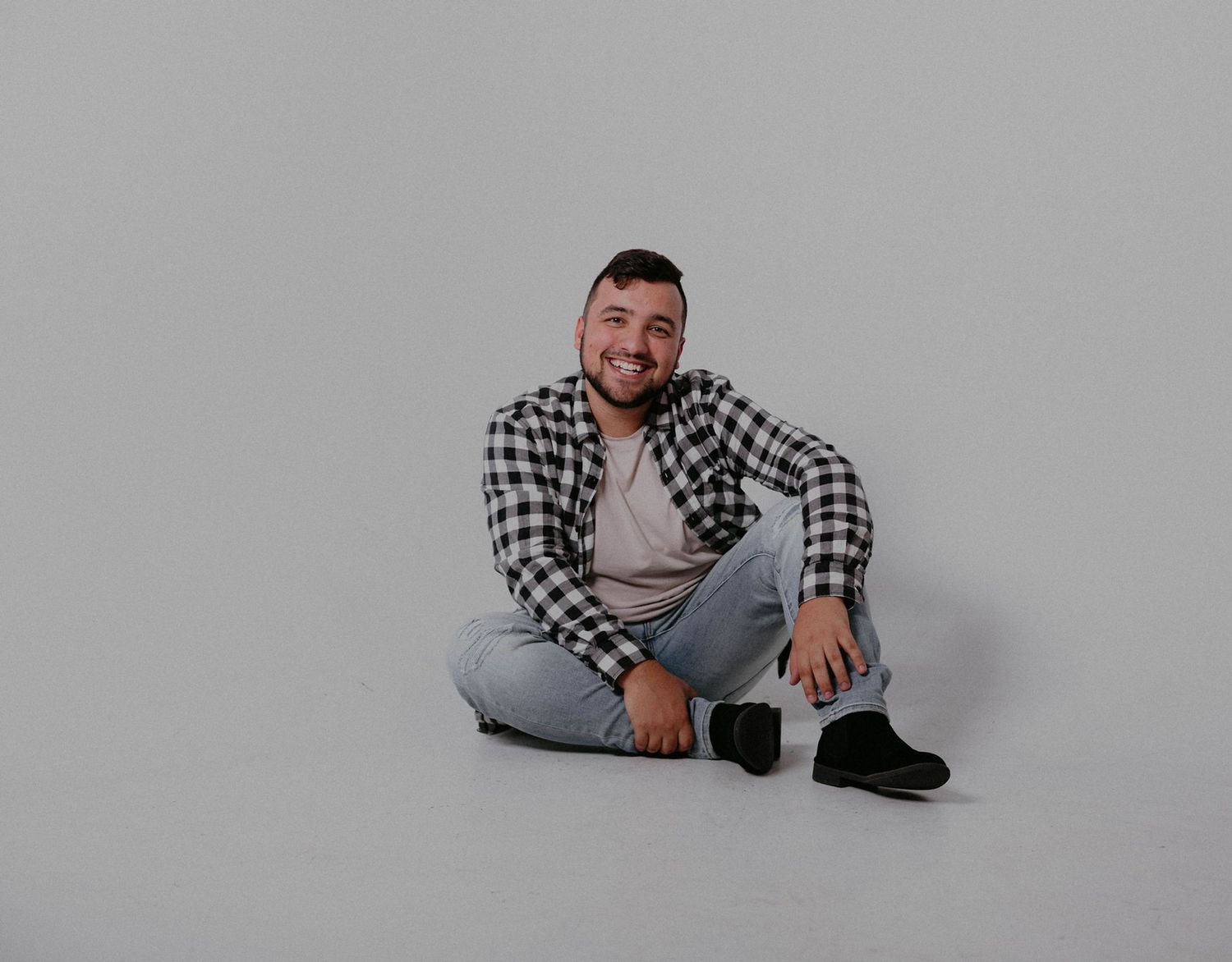 man sitting on floor smiling