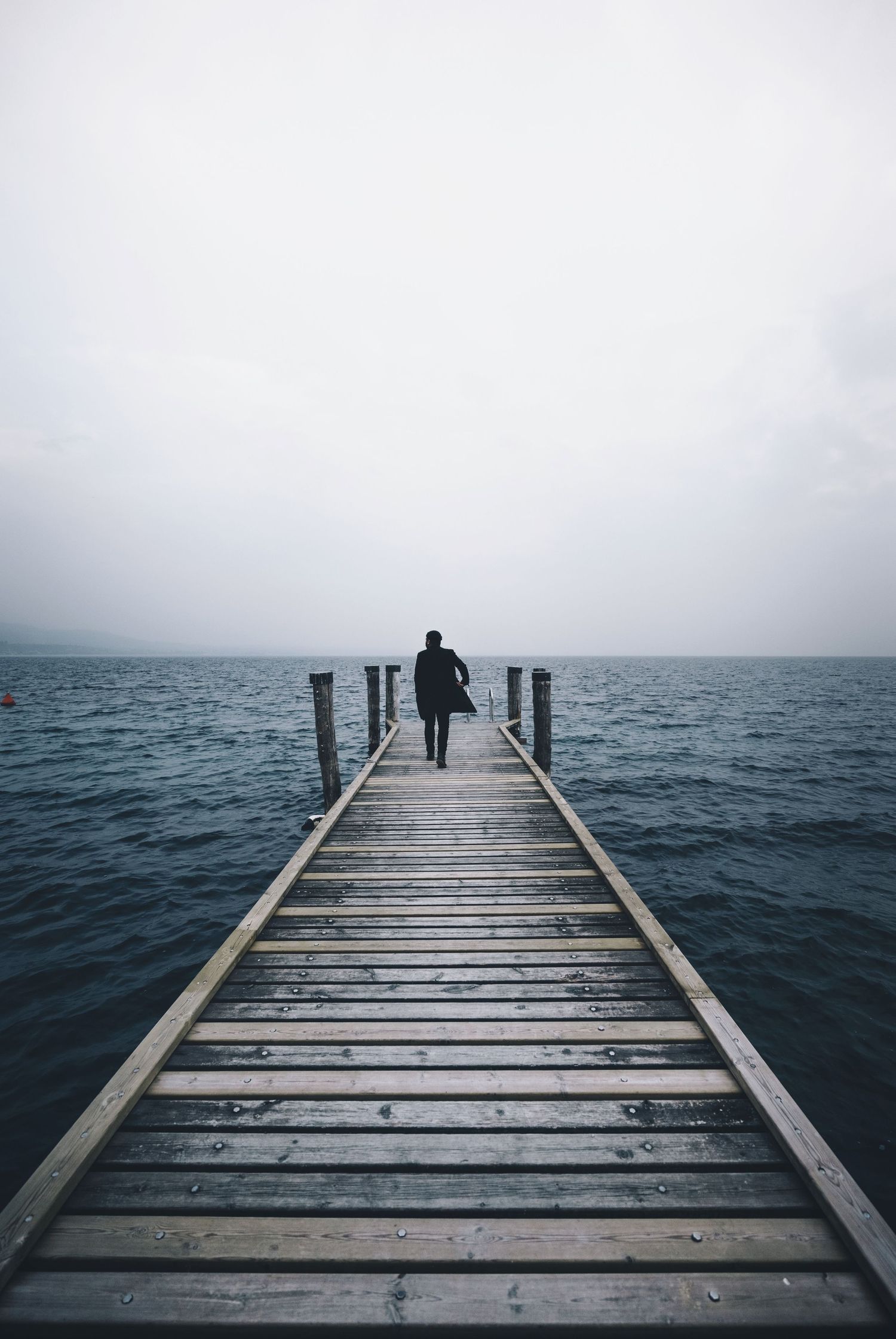 un homme seul face à la mer et l'horizon qui est en phase de transition de vie (séparation, deuil, expatriation)