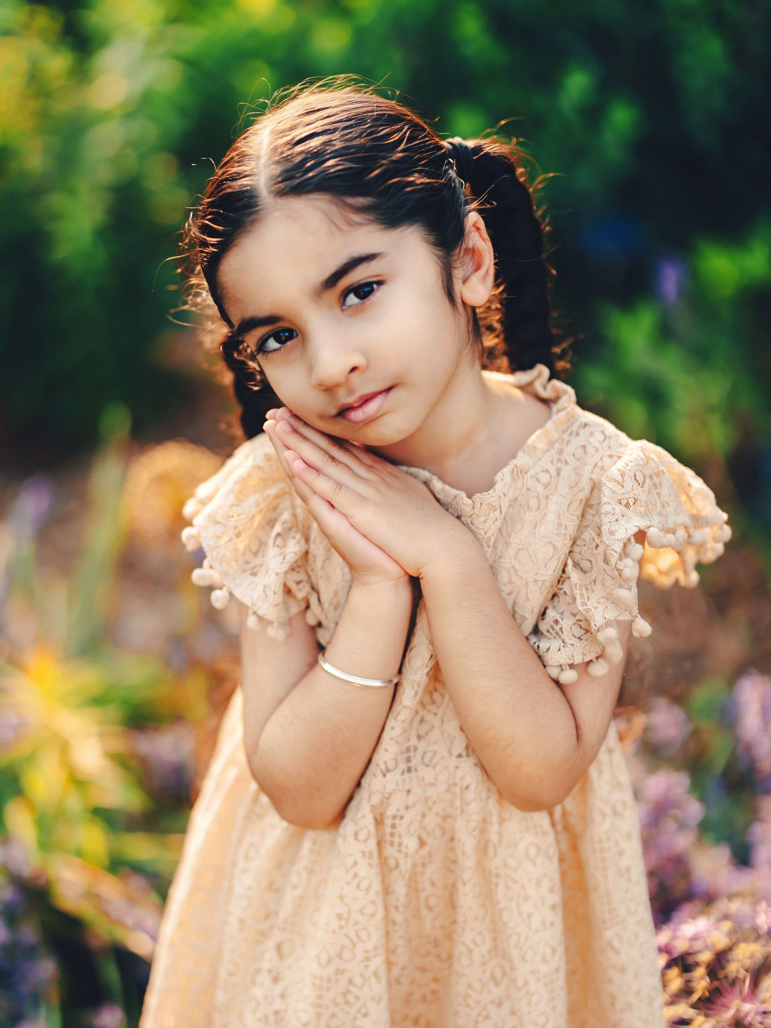 Young girl in a delicate gold dress posing in a dreamy outdoor floral setting. Toronto fine art photography.