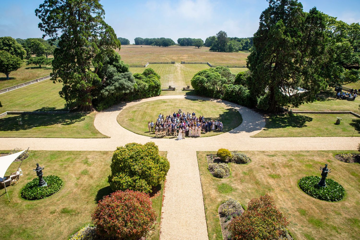 Aerial view of a grand estate with manicured gardens and walking paths.