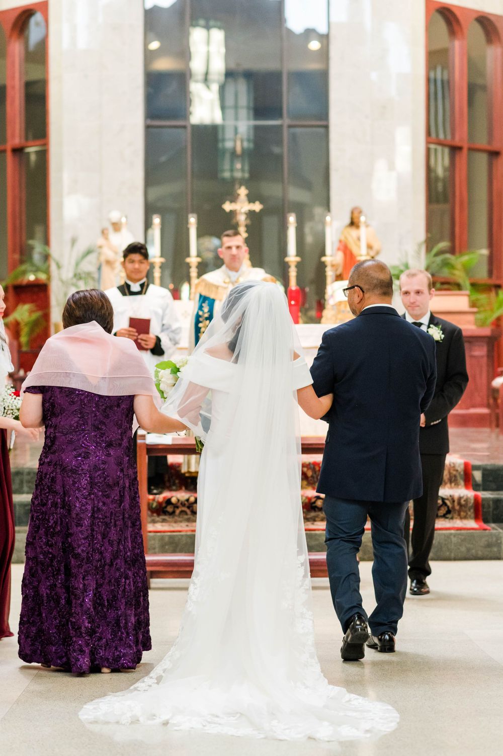 Catholic Wedding Photography at St. Monica Catholic Church, Edmond OK. Bride walking down catholic church aisle.