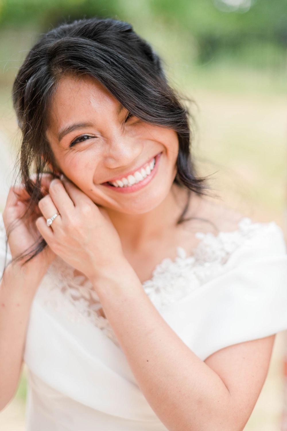 Bride putting on earrings ahead of her catholic wedding at St. Monica Catholic Church in Edmond, OK.