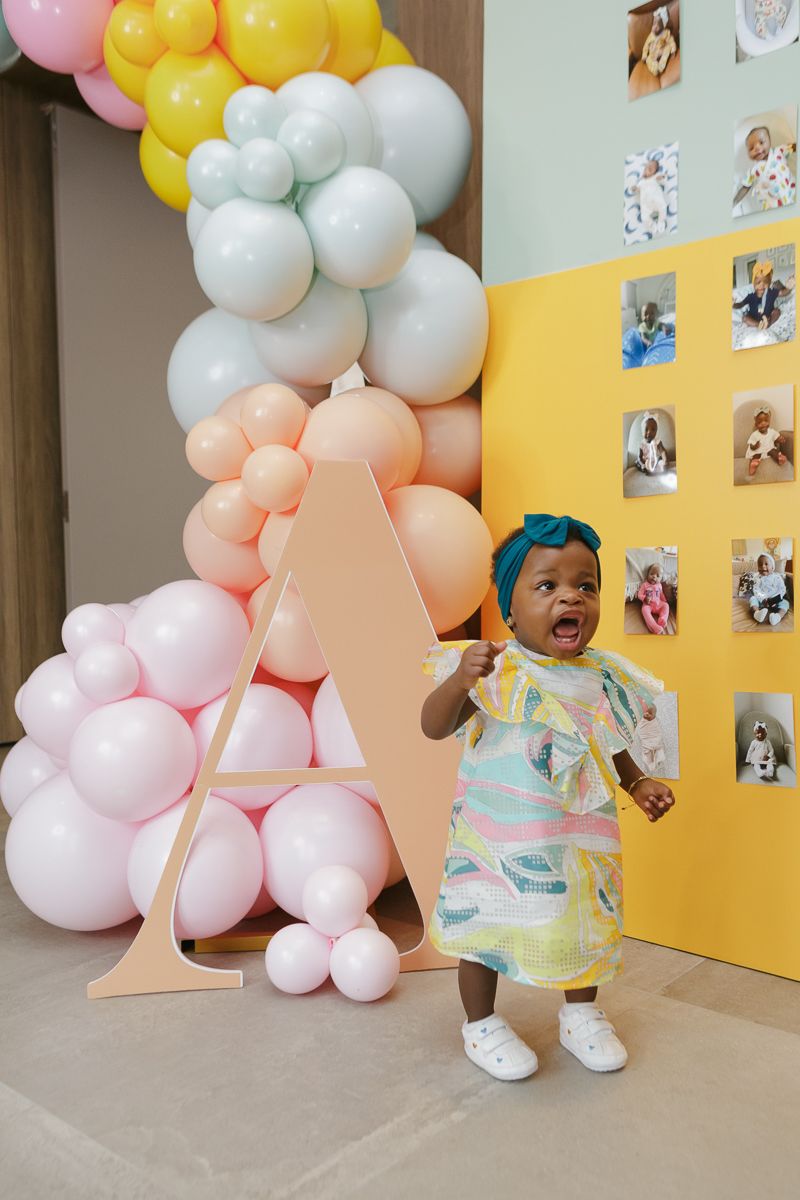 Birthday girl smiling at party entrance candid by NYC family photographer Paula Ortiz