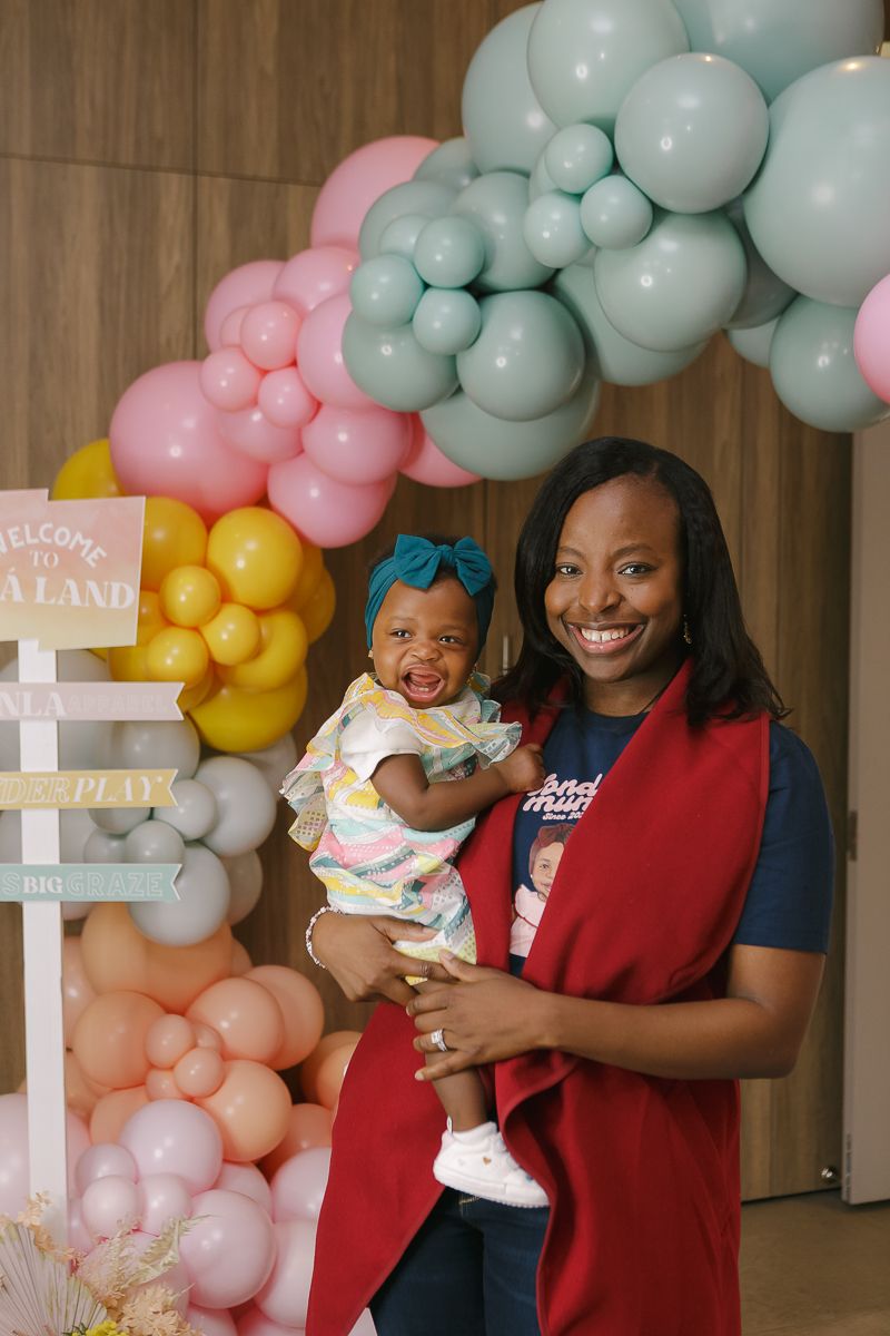Mom holding smiling birthday girl by NYC family photographer Paula Ortiz