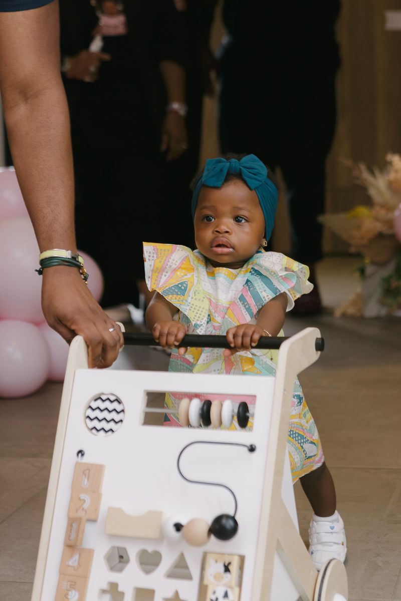 Birthday girl entering party with stroller by NYC family photographer Paula Ortiz