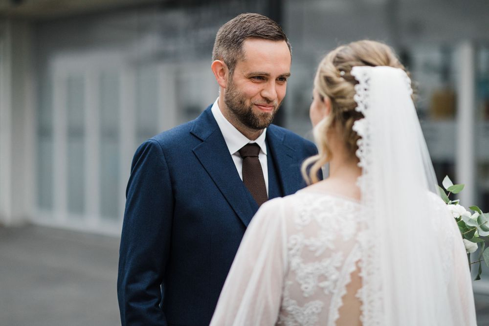 Intimate moment captured between newlyweds during their outdoor wedding portraits.