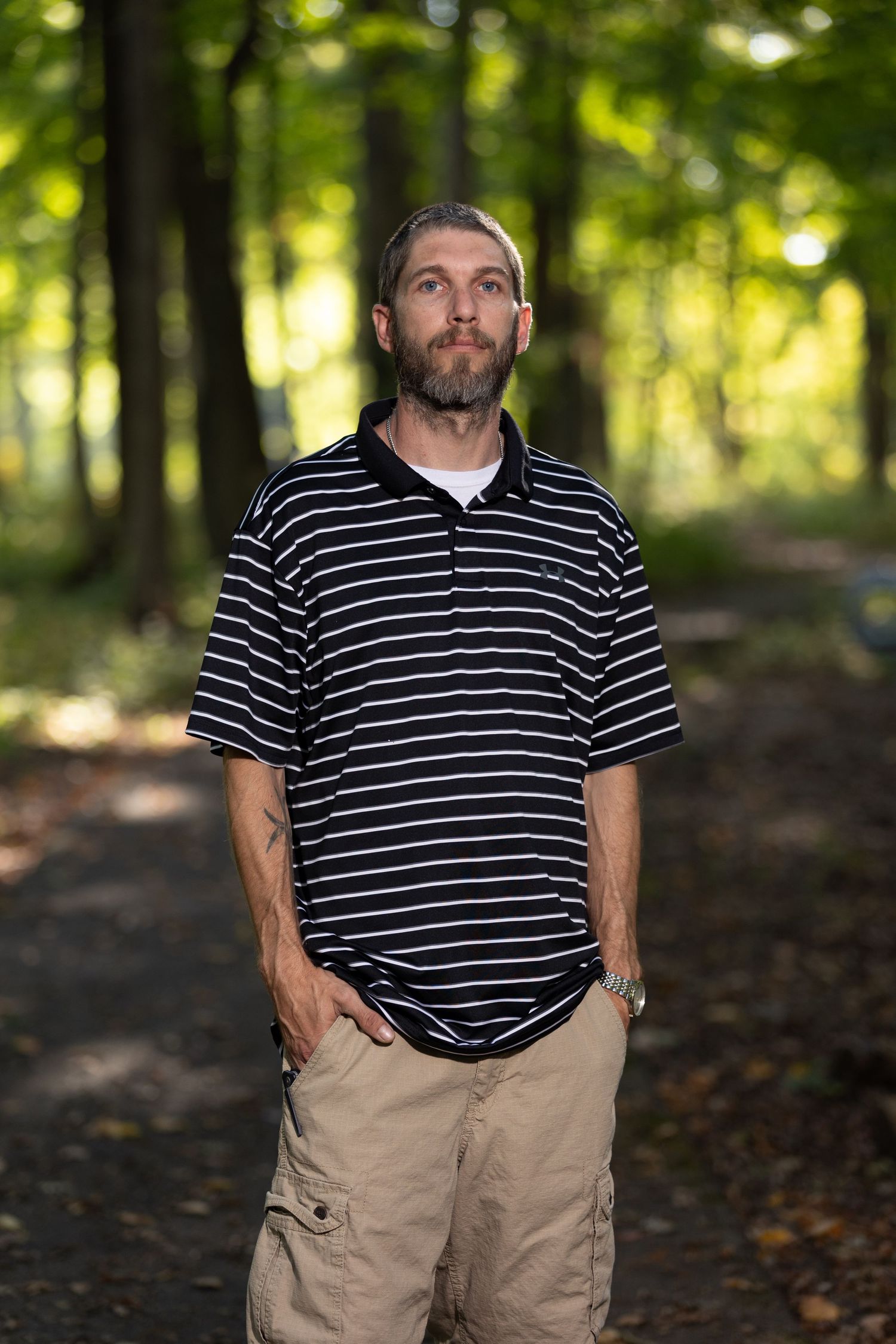 A man posing with hands in pockets.