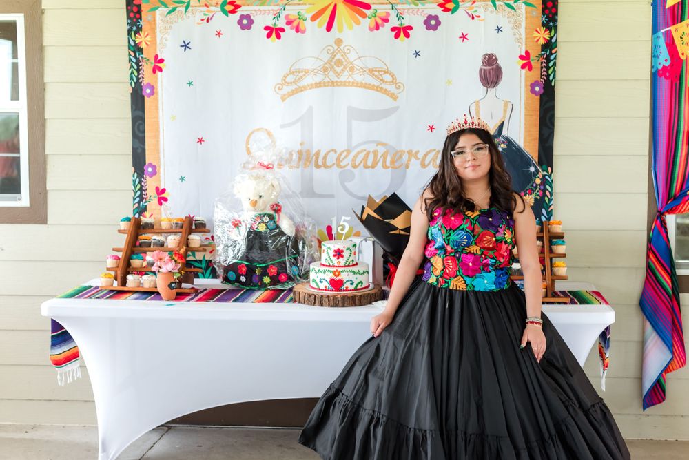 a teen girl in a formal black dress poses for her quinceanera at Hardee Lakes County Park in Bowling Green, Florida