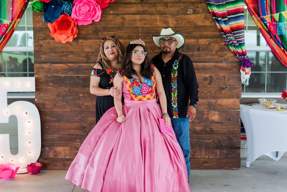 teen girl poses with her parents at quinceanera celebration Hardee Lakes County Park in Bowling Green, Florida