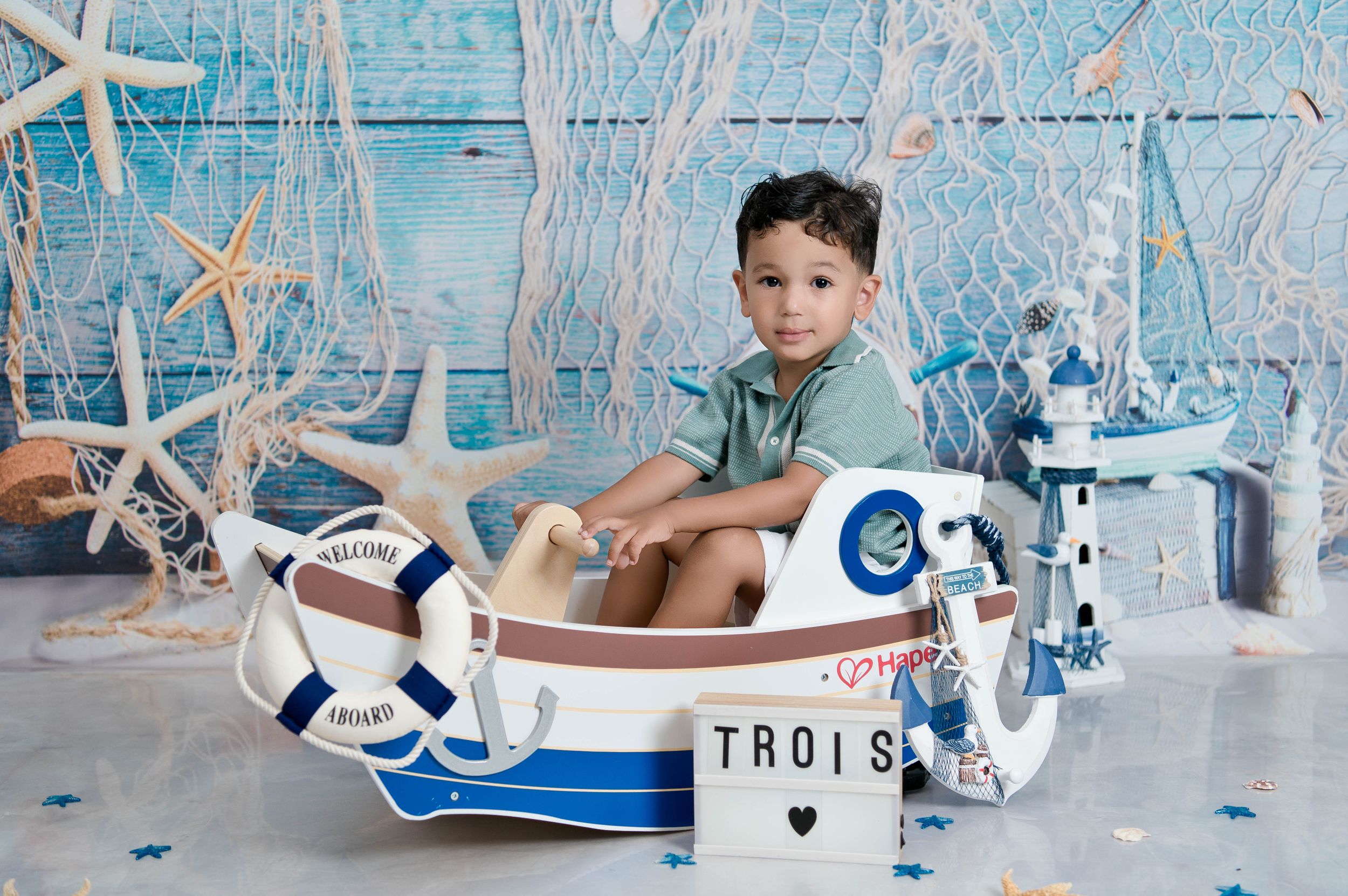 Nautical themed photo setup with blue and white decorations featuring anchors and starfish.