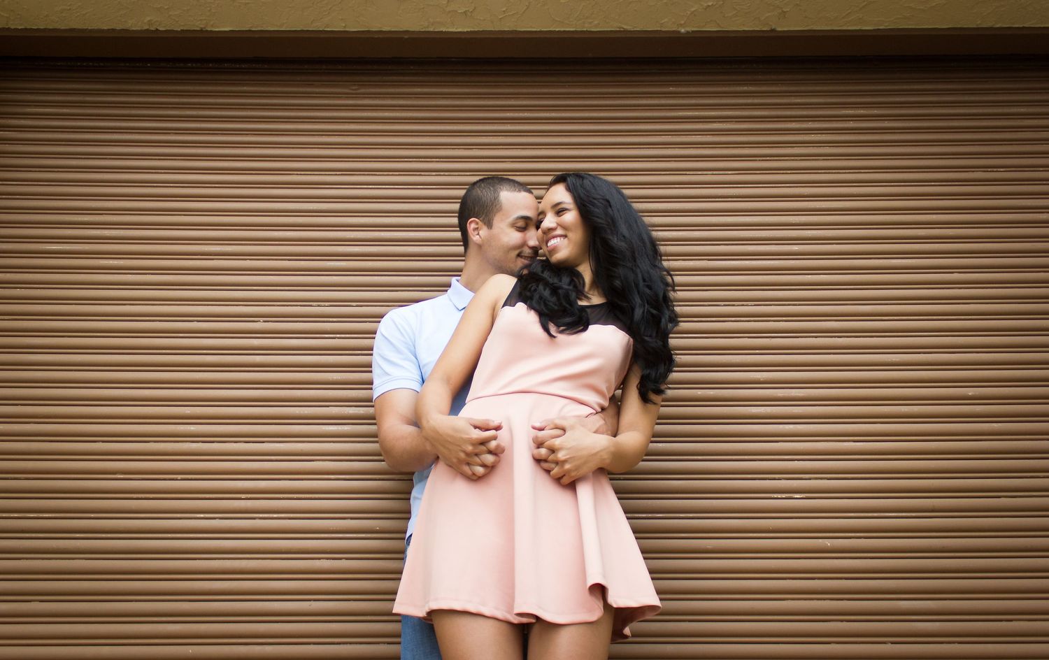 Series of romantic couple photos against a brown garage door background.