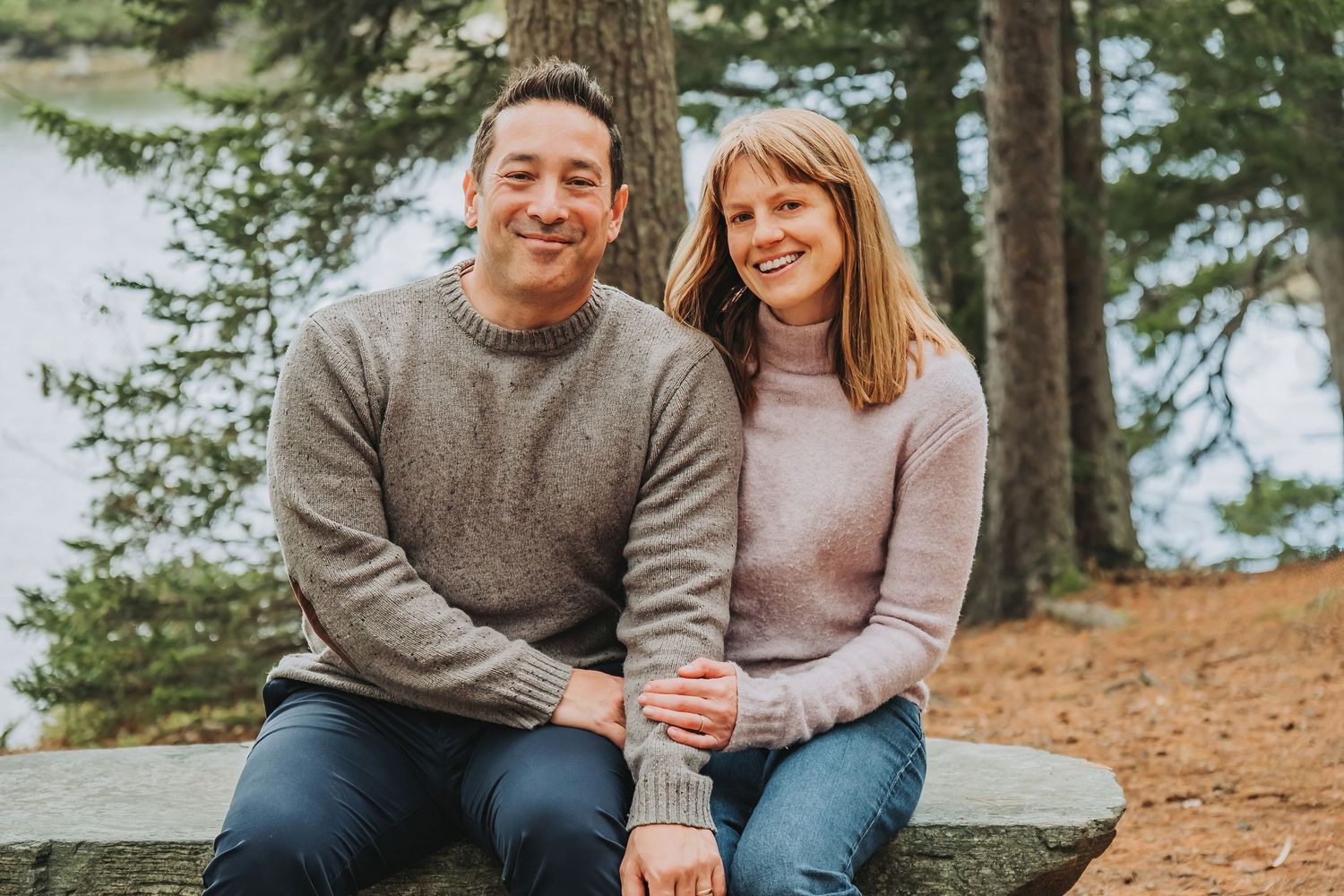 A smiling couple poses for a shot near the water at the Maine Botanical Gardens in Boothbay, Maine.